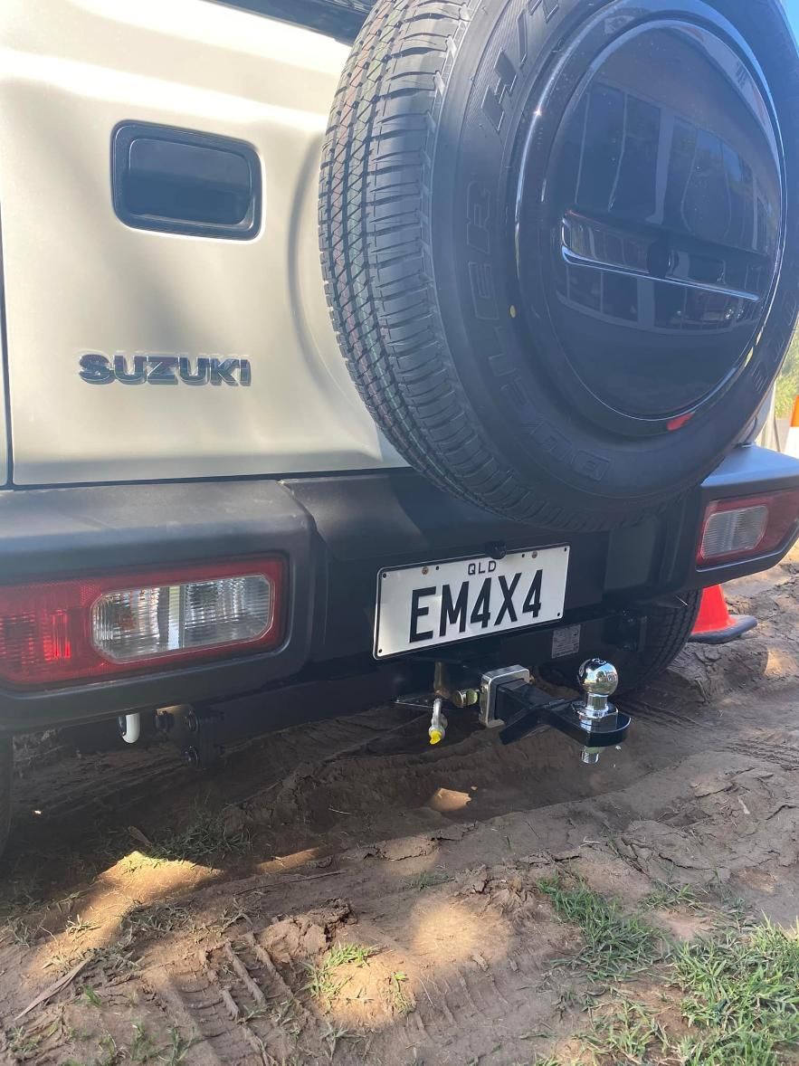 A Suzuki Jimny With a Trailer Attached to It is Parked in the Dirt — Emerald 4x4 in Emerald, QLD