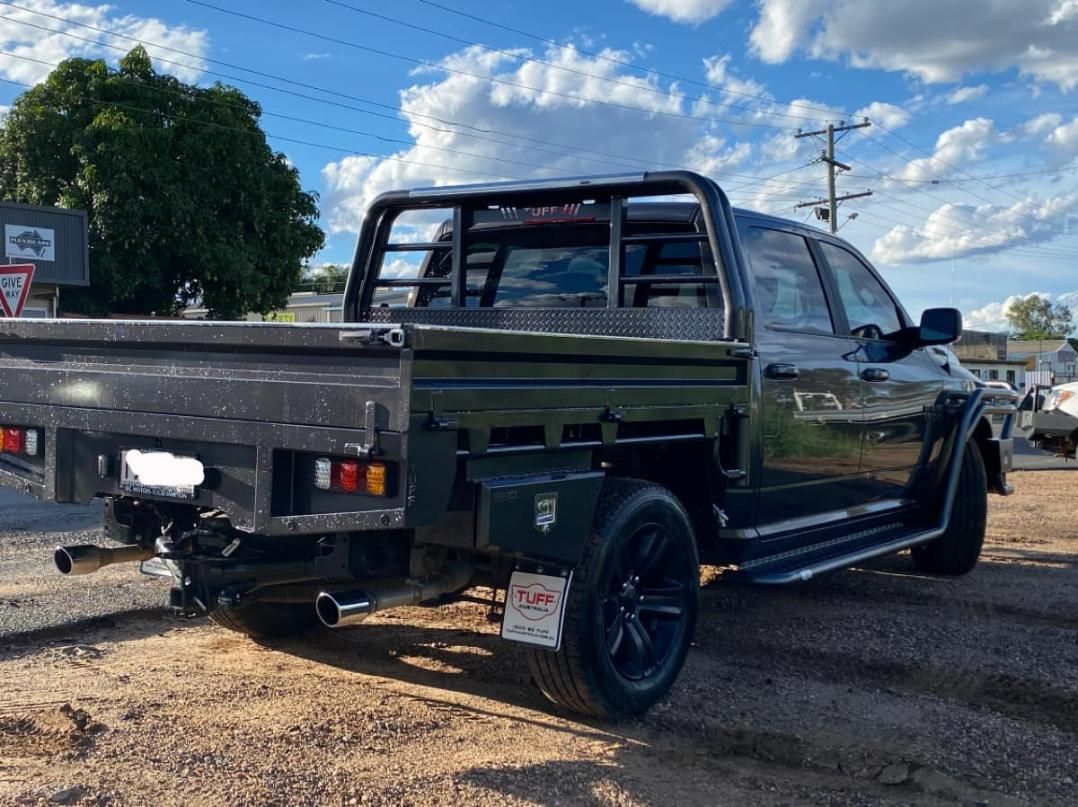 A Black Truck With a Flat Bed is Parked in a Dirt Lot — Emerald 4x4 in Emerald, QLD
