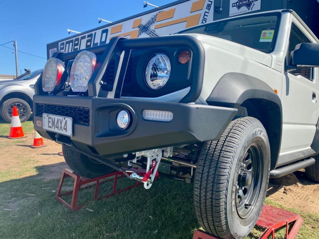 A White Jeep With a Black Bumper is Parked on a Red Ramp — Emerald 4x4 in Emerald, QLD