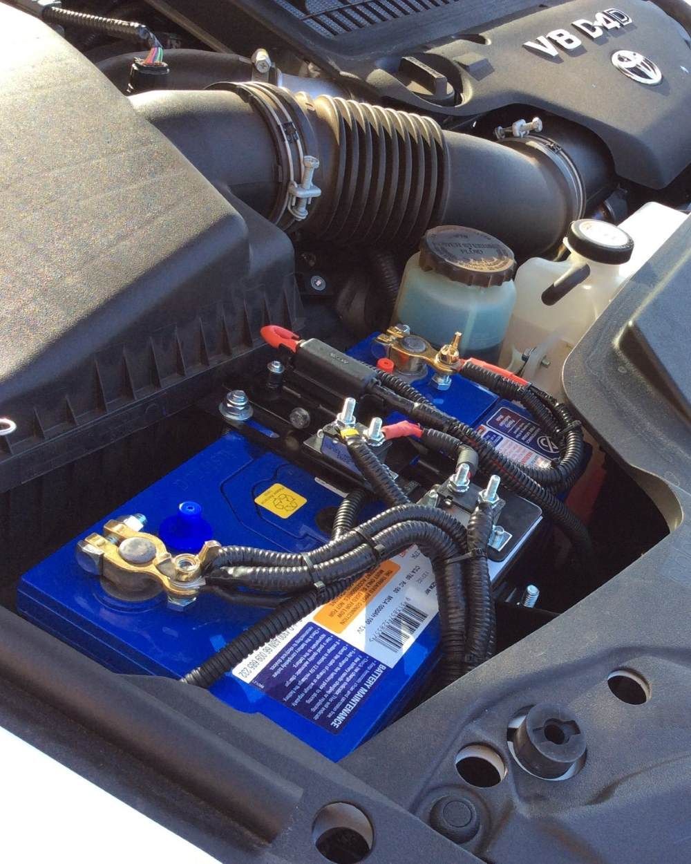 A Blue Battery is Under the Hood of a Car — Emerald 4x4 in Emerald, QLD
