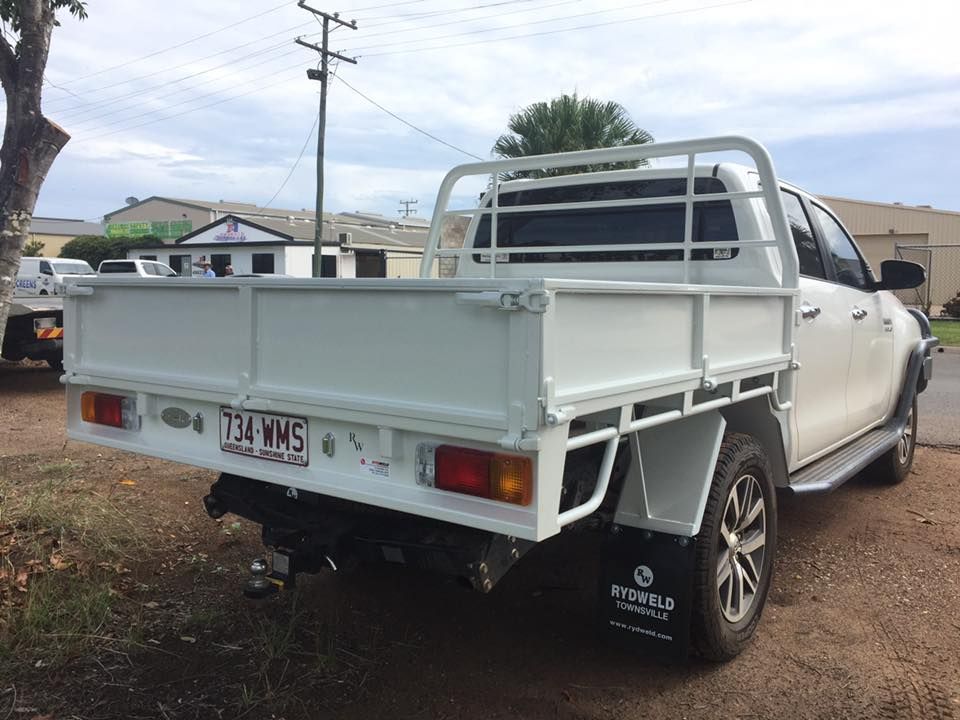 A White Truck With a Tray on the Back is Parked on the Side of the Road — Emerald 4x4 in Moranbah, QLD