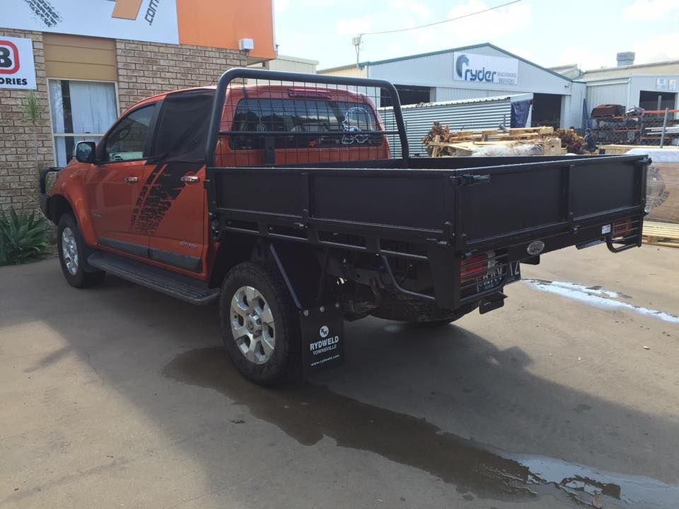 A Red Truck With a Black Tray is Parked in Front of a Building — Emerald 4x4 in Capella, QLD