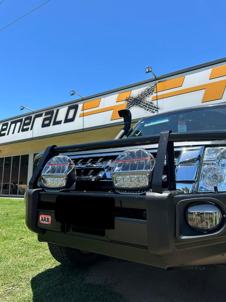 A Car is Parked in Front of a Building That Says Emerald — Emerald 4x4 in Emerald, QLD