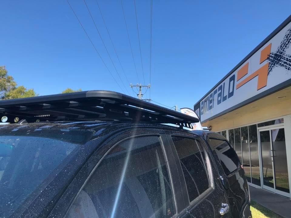 A Black Suv With a Roof Rack on Top of It is Parked in Front of a Building — Emerald 4x4 in Emerald, QLD