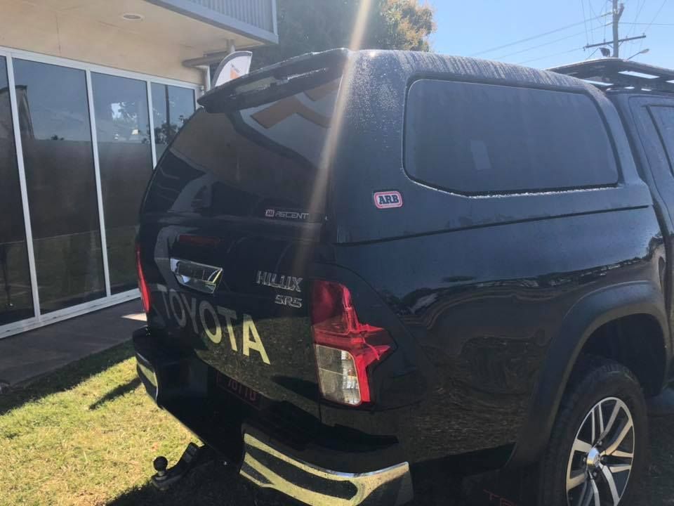 A Black Toyota Hilux is Parked in Front of a Building — Emerald 4x4 in Emerald, QLD