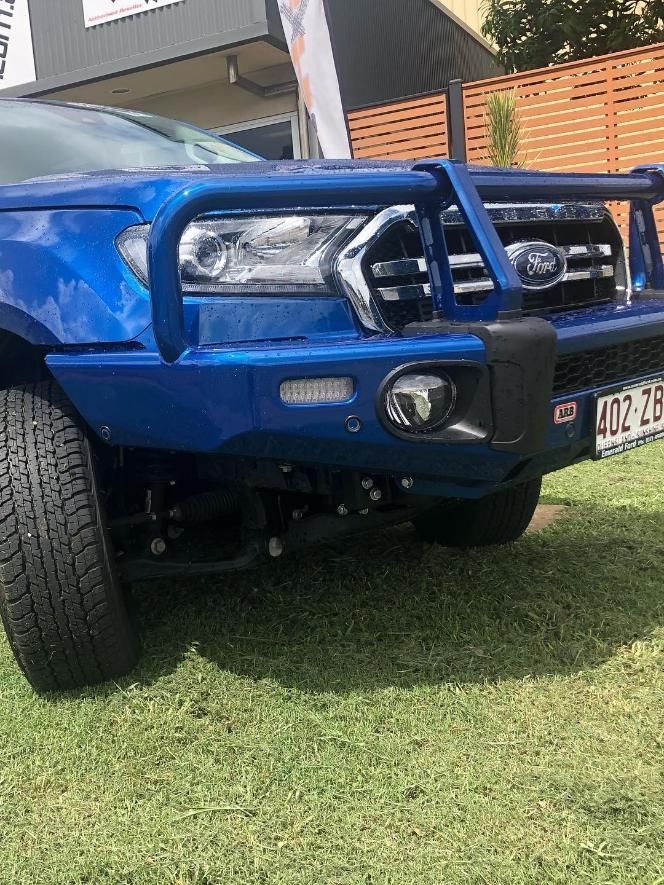 A Blue Truck is Parked on the Grass in Front of a Building — Emerald 4x4 in Emerald, QLD