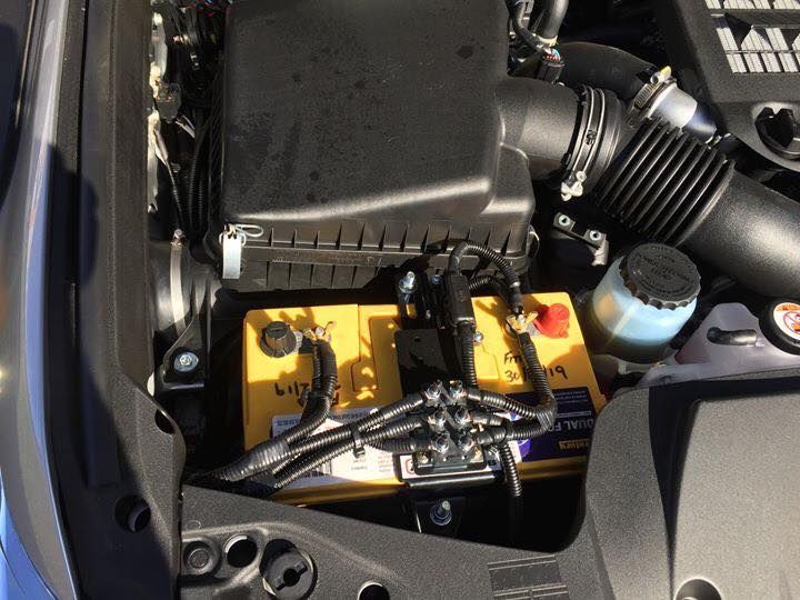 A Yellow Battery is Sitting Under the Hood of a Car — Emerald 4x4 in Emerald, QLD