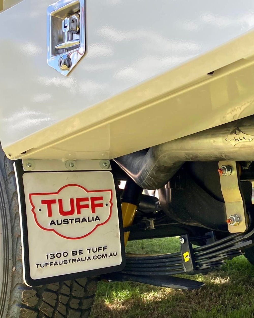 A White Truck With a License Plate That Says Tuff Australia is Parked in the Grass — Emerald 4x4 in Emerald, QLD