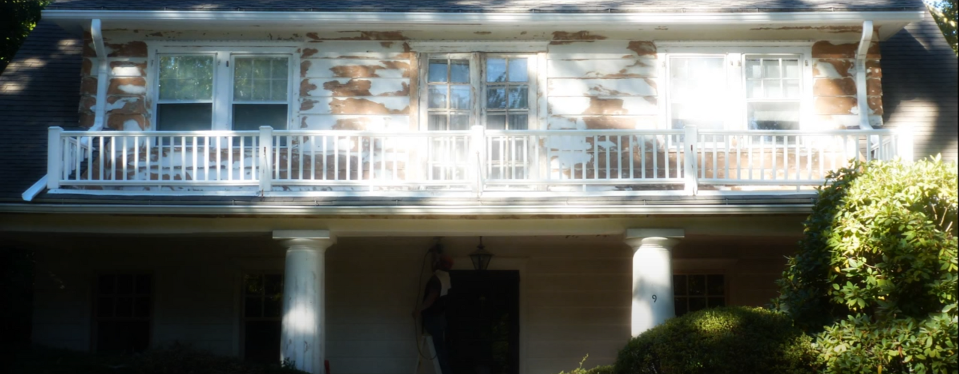 exterior of a home that is weathered and missing paint