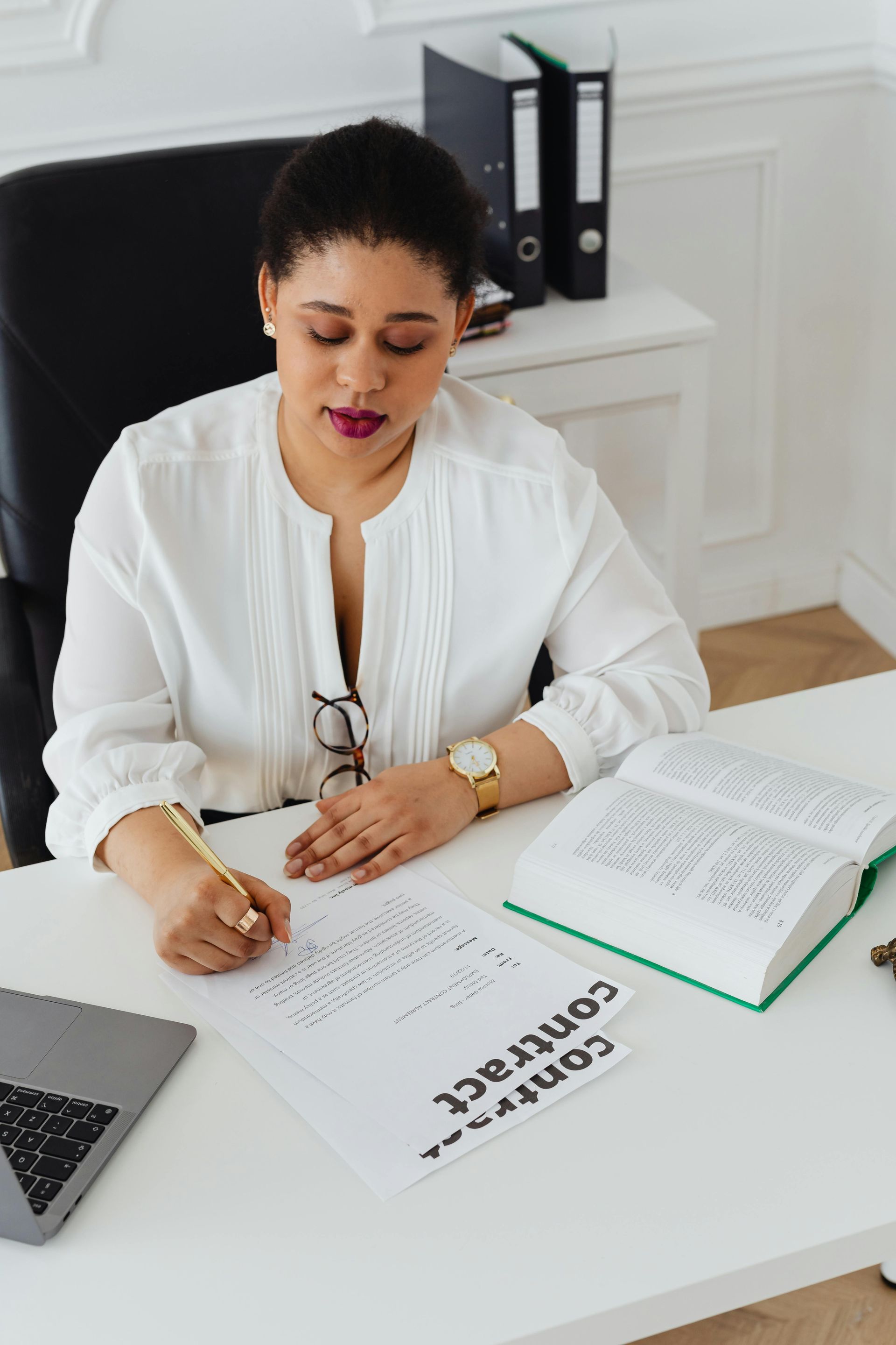 Three little girls are sitting on a couch with a baby.
