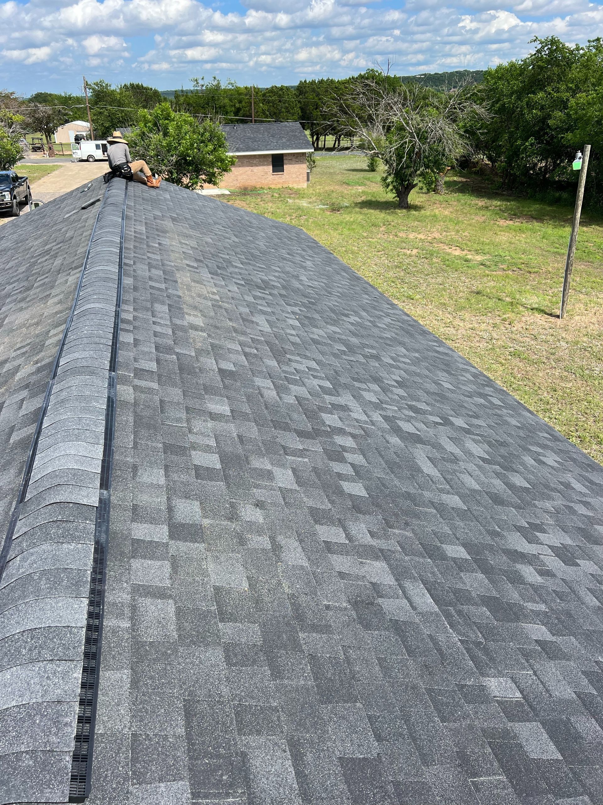 A man is working on the roof of a house.