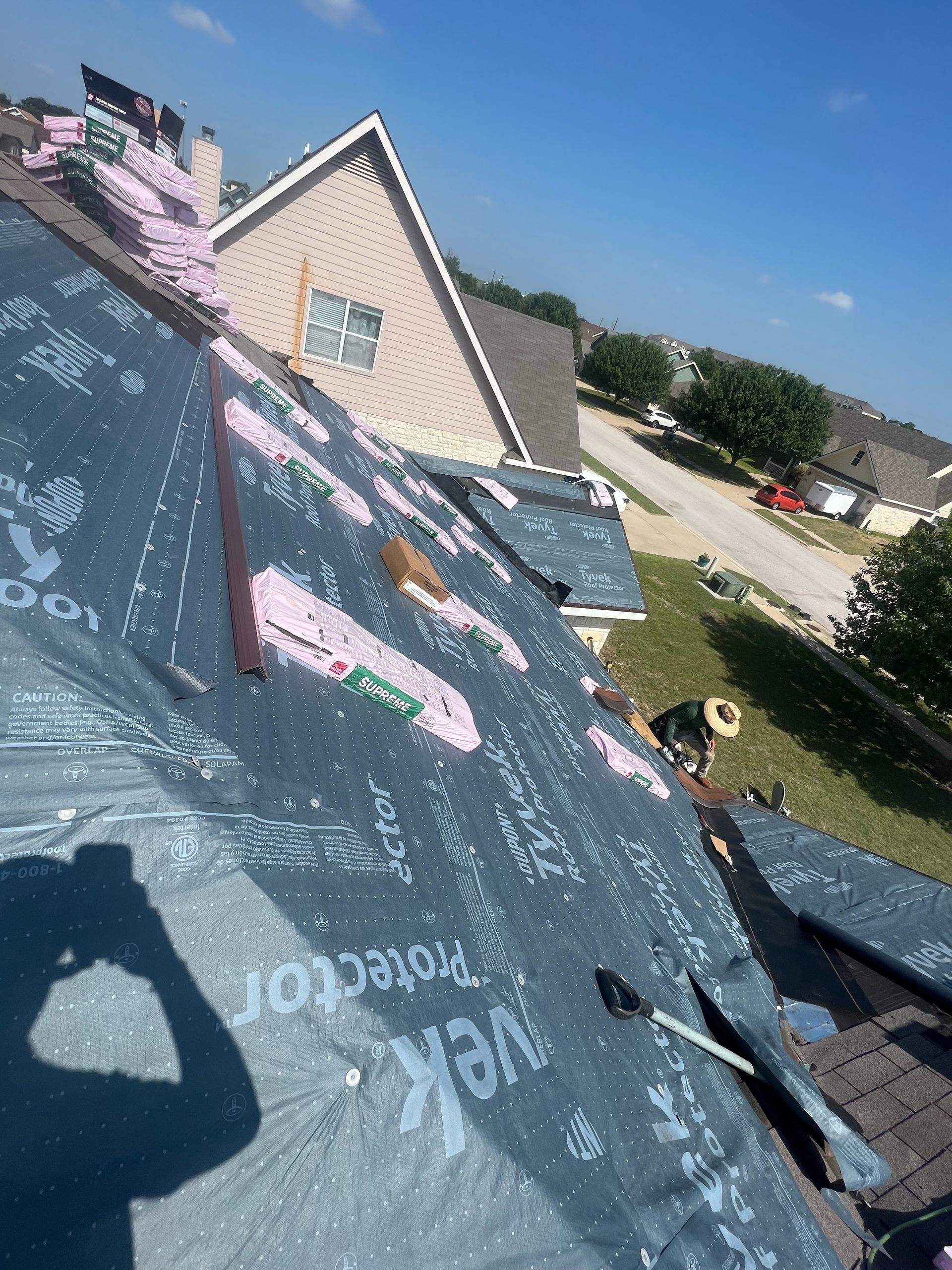 A person is taking a picture of a roof with a camera.