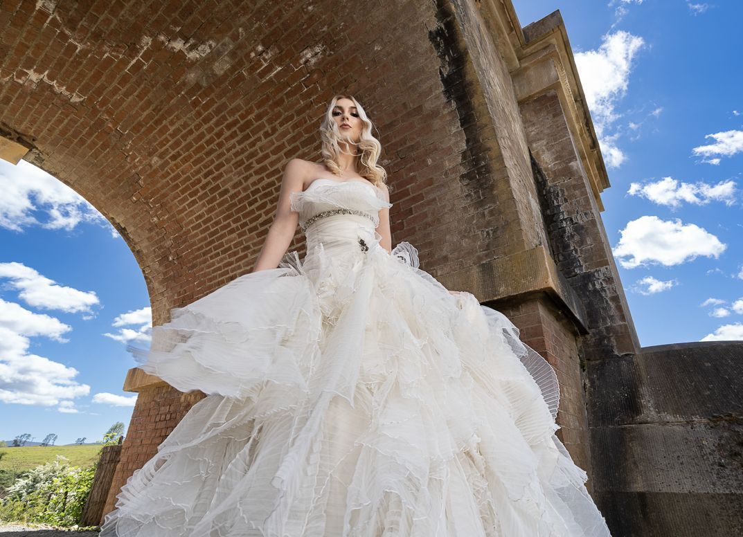 side view white gown with detailed beading, flowers and tulle