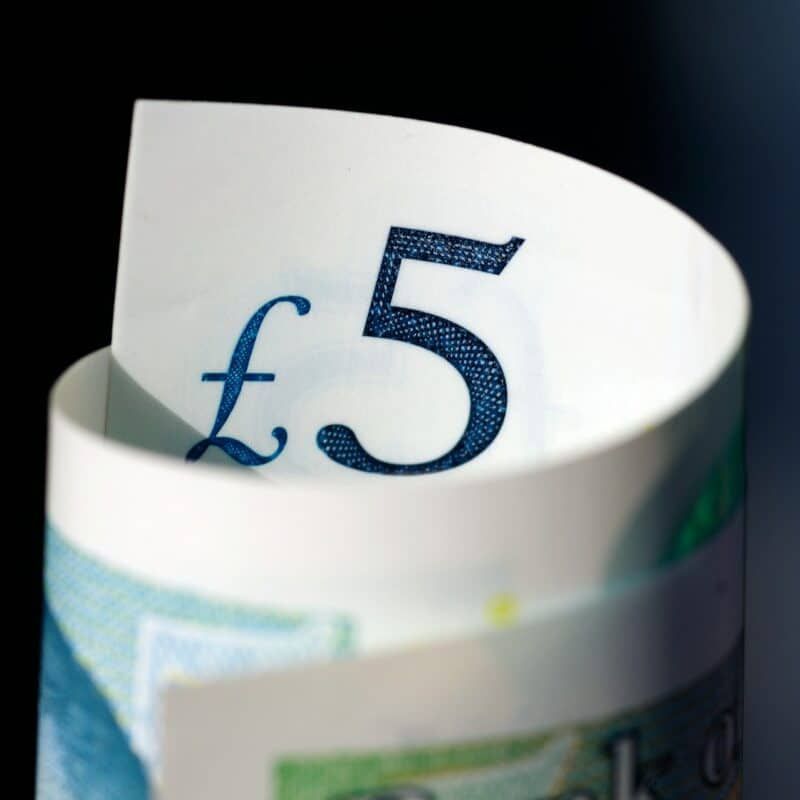 A roll of money with the number 5 on it