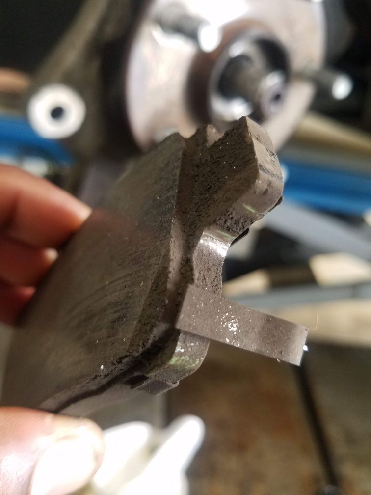 A person is holding a piece of metal in their hand.