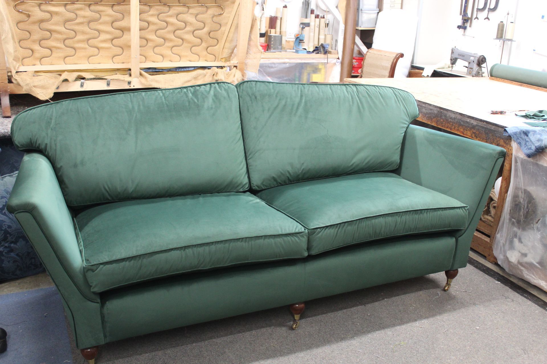 Green velvet cushioned sofa Legs with castors