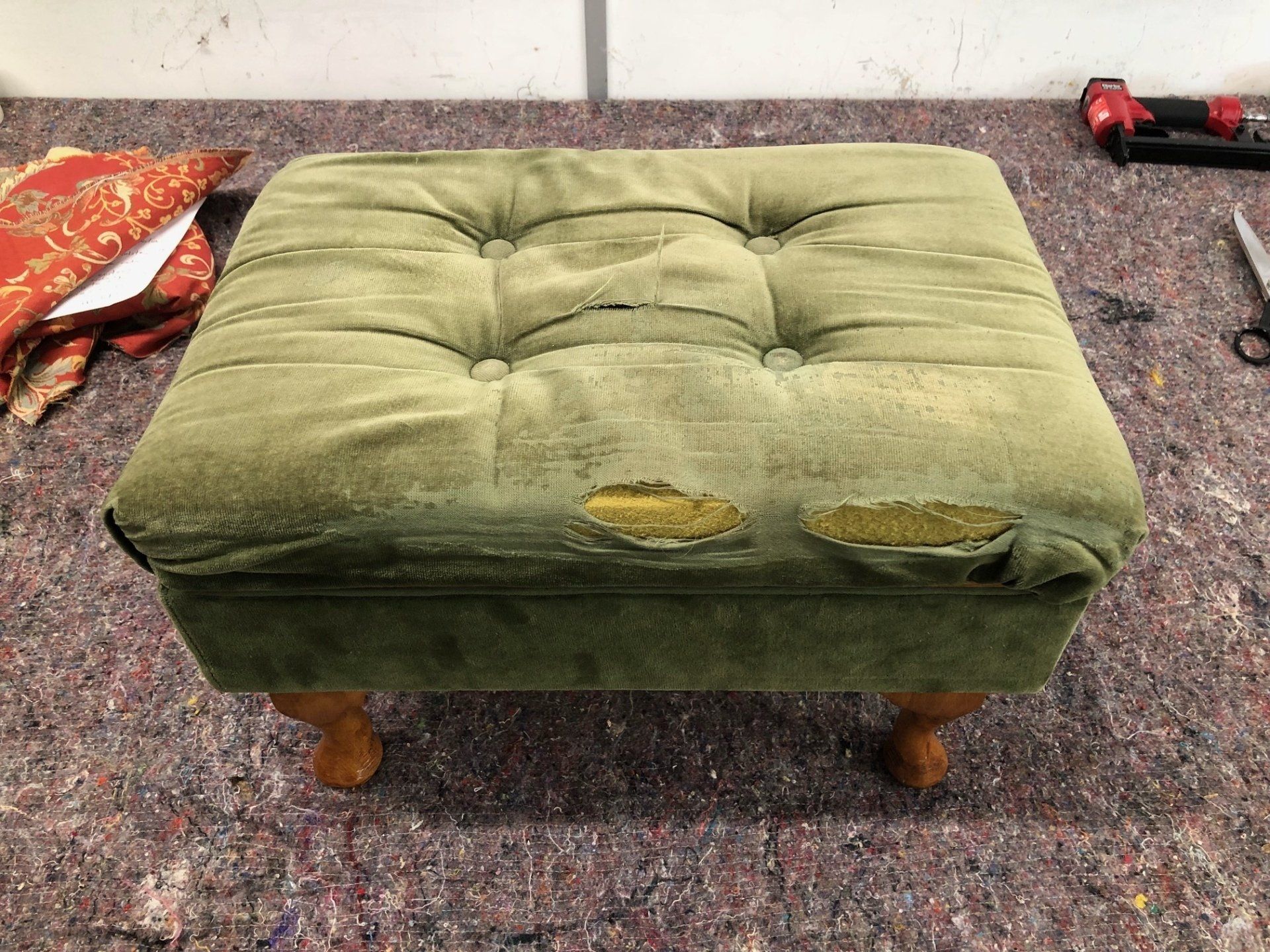 old green velvet footstool worn before