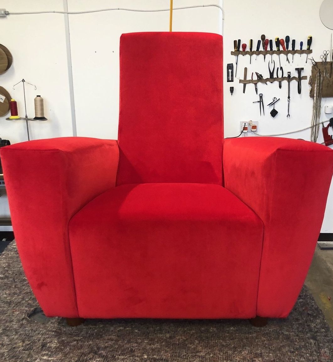 Bright red velvet vintage chair renewed after