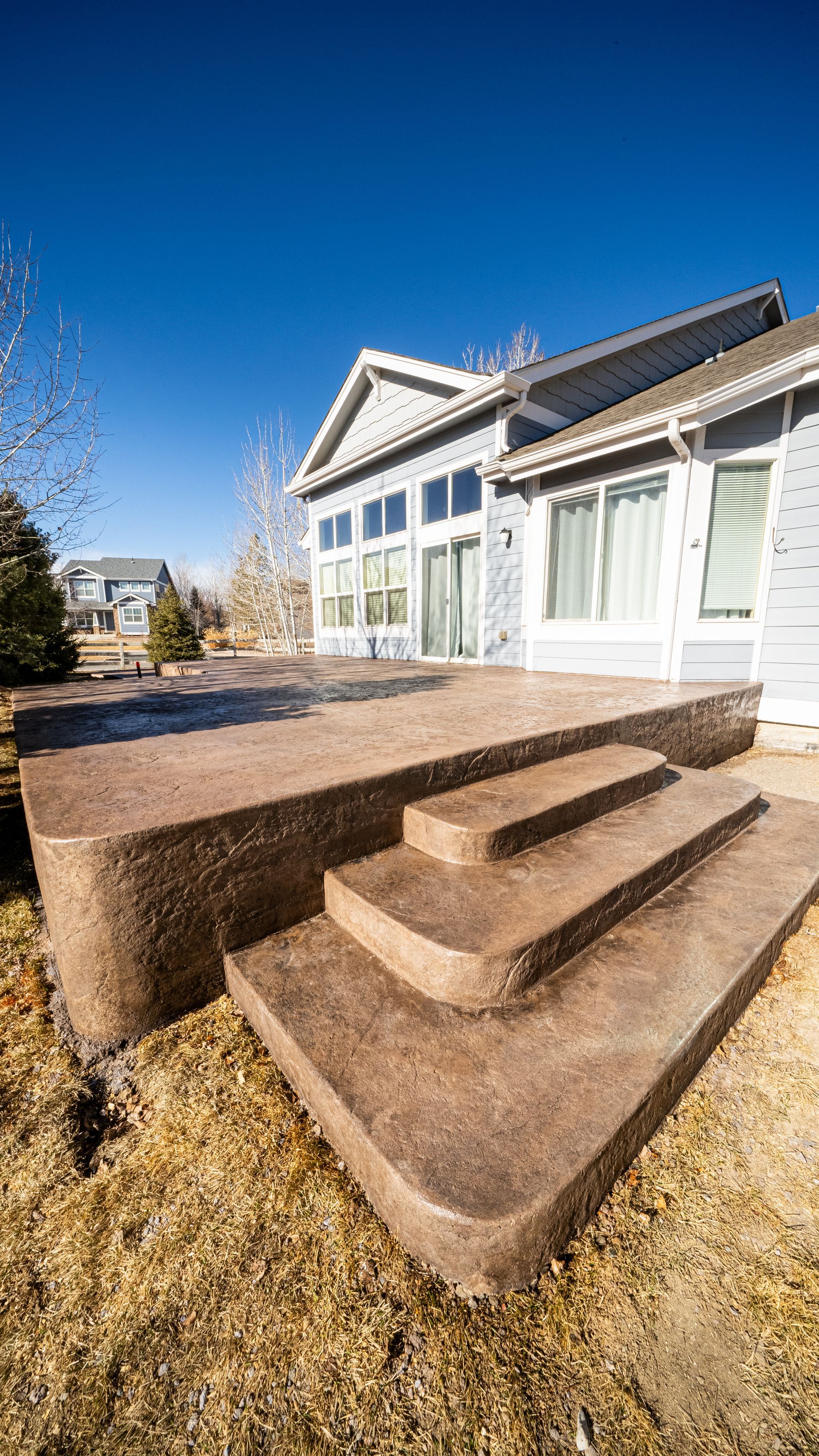 A concrete walkway is being built in a yard.
