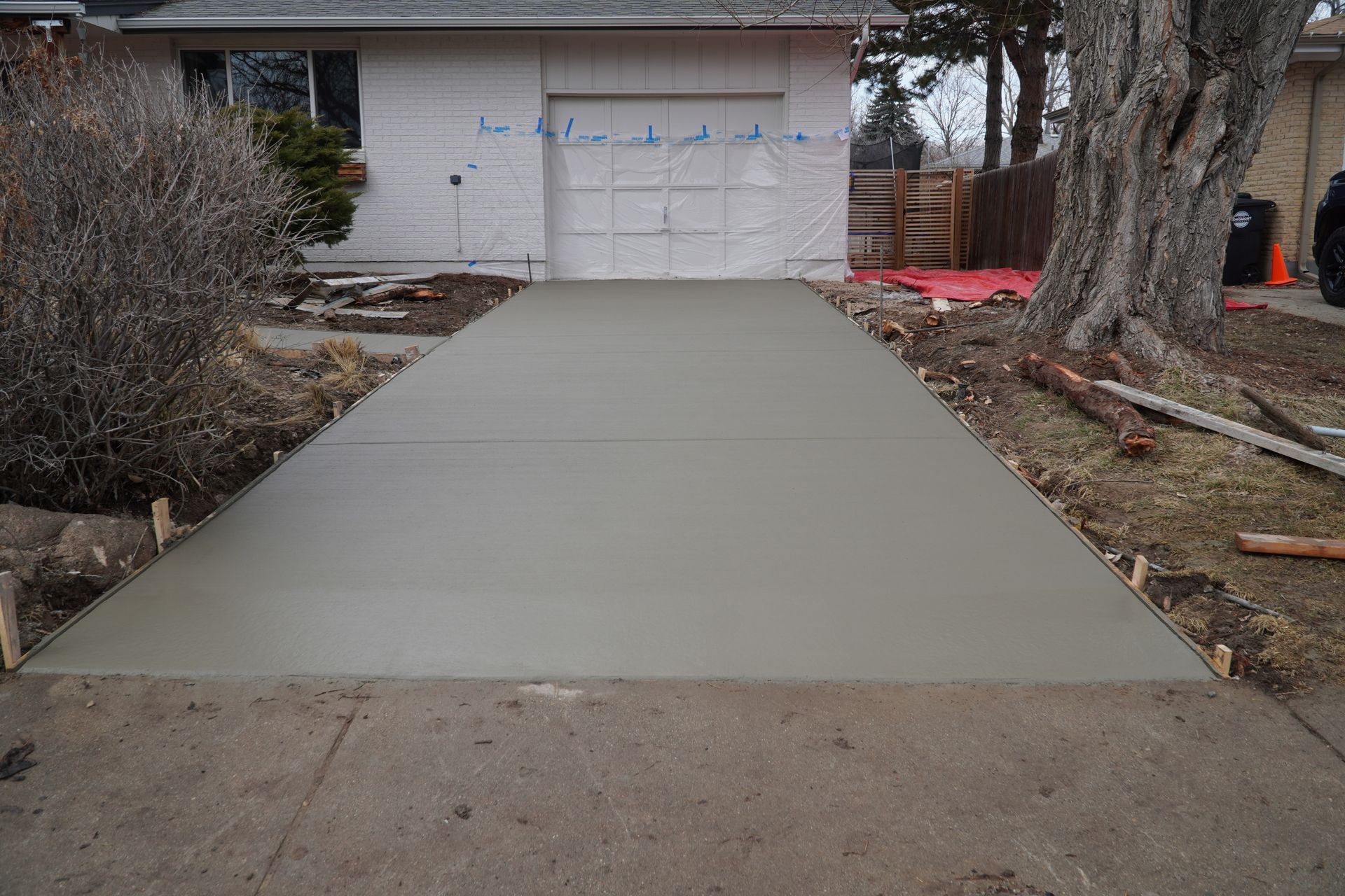 A house with a concrete driveway leading to it