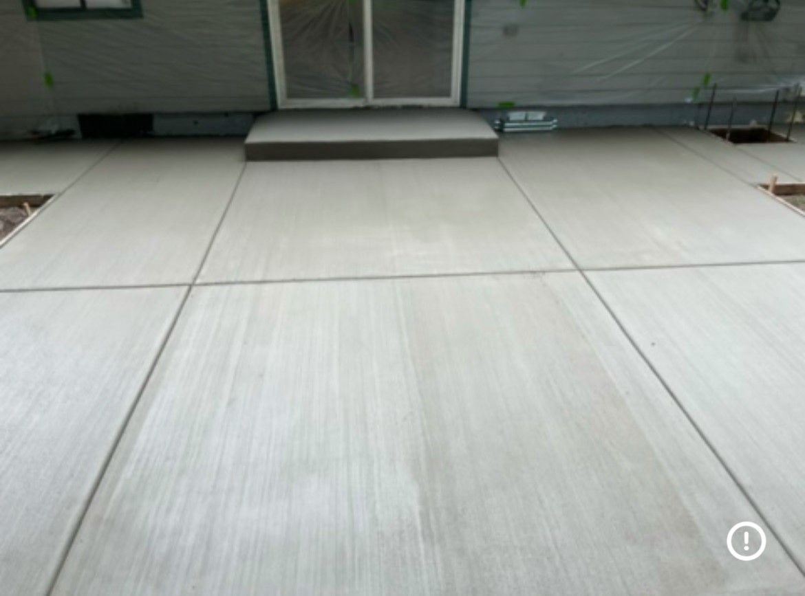 A white concrete floor with a sliding glass door in the background.