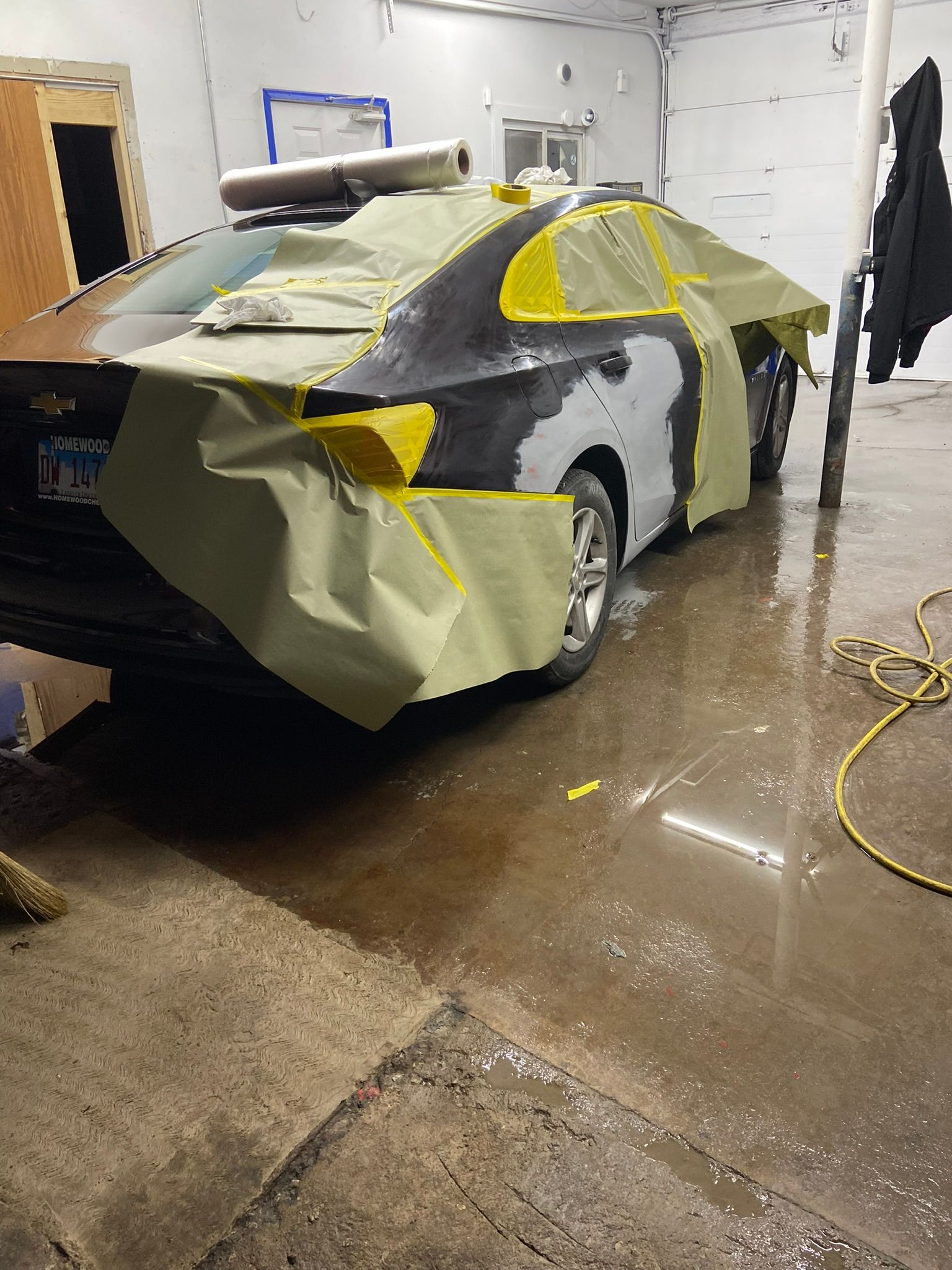 A Car Is Being Painted in A Garage — Chicago, IL — Ecuamex Autobody Inc.