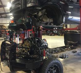 A truck is being worked on in a garage. | Aus Tex Transmissions
