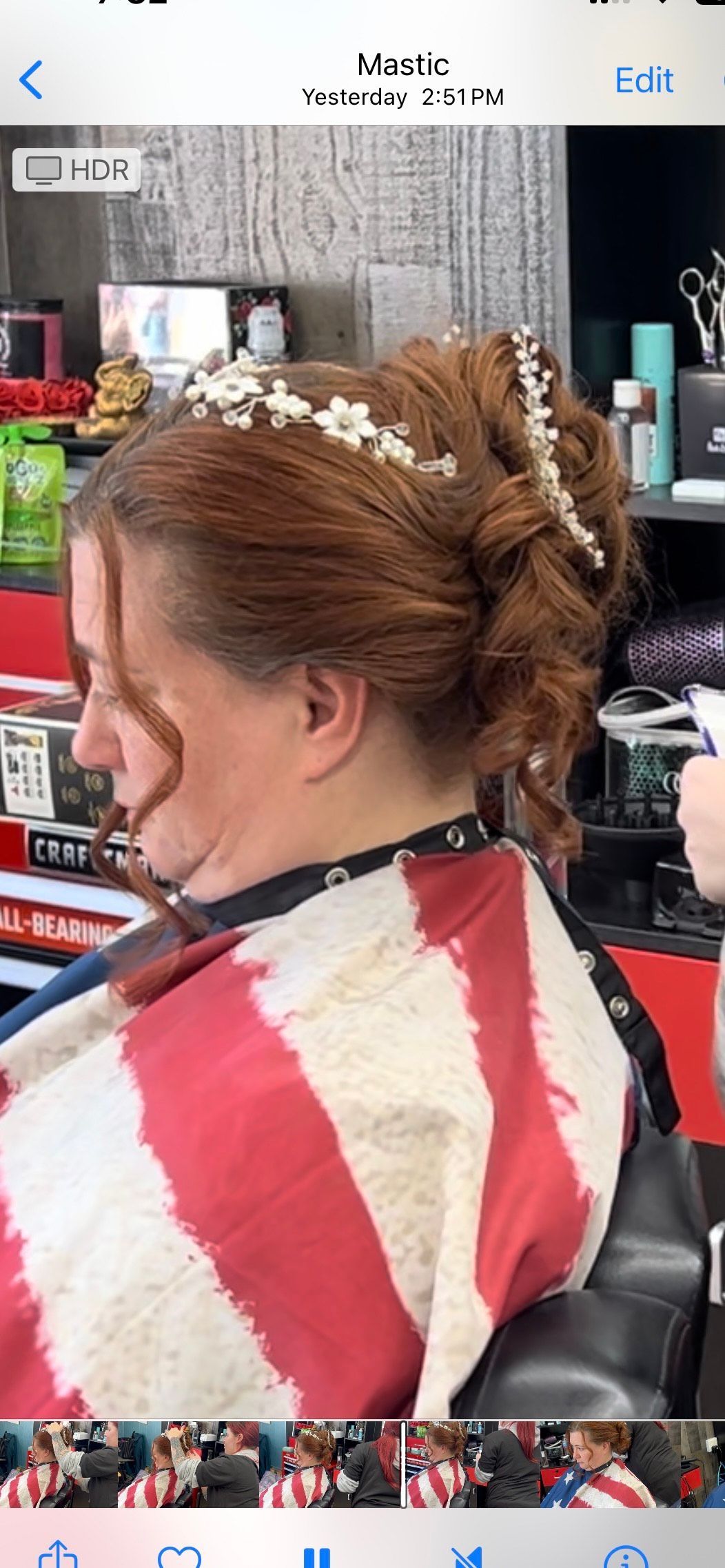 Close-up of shaving kit on gray fabric: razor, two brushes, and a container of balm.