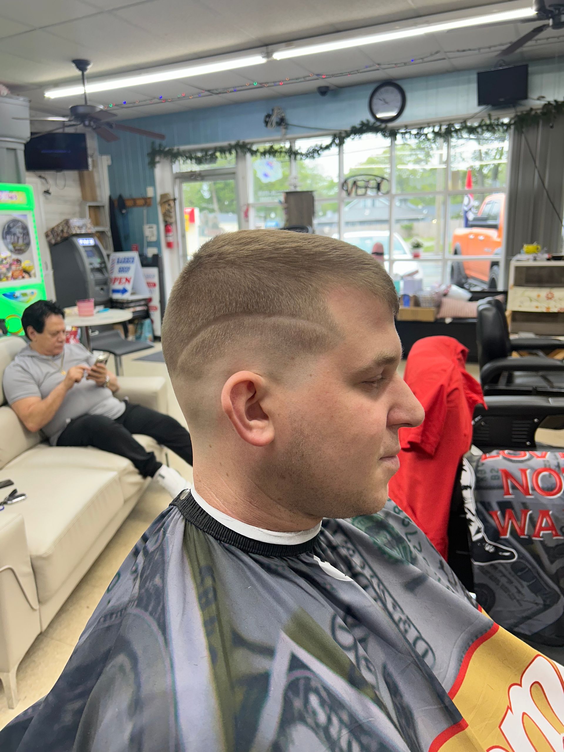 Man getting a shave with a straight razor at a barbershop.