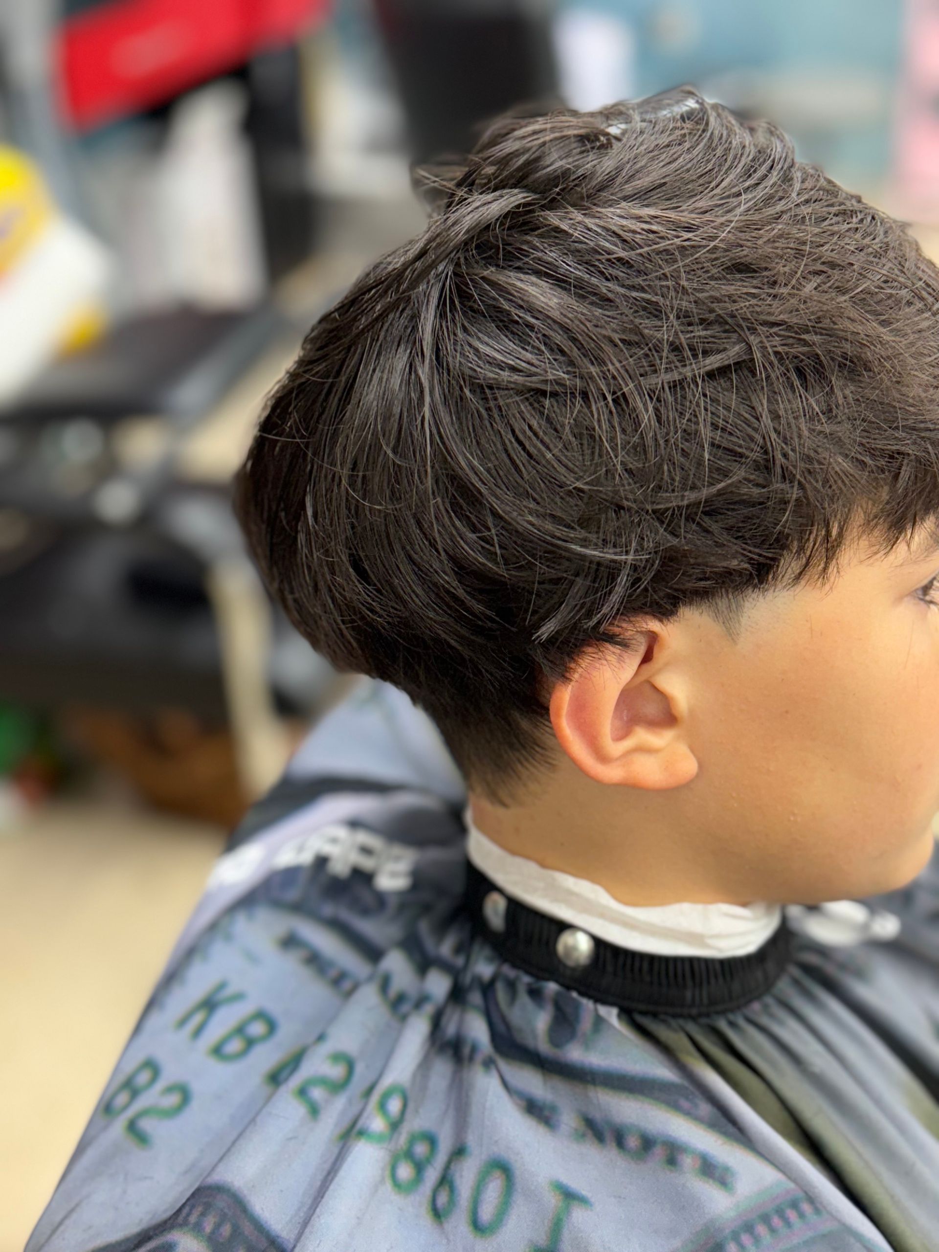 Hair clippers cutting a person's hair. Close-up, black and white.