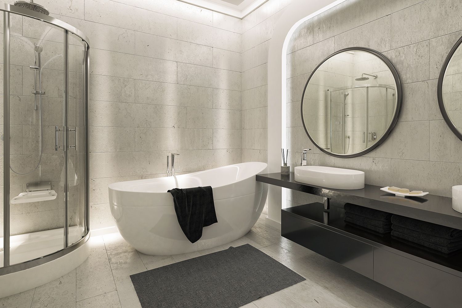 Modern bathroom with a free-standing tub, shower, black vanity with sink, and round mirrors.