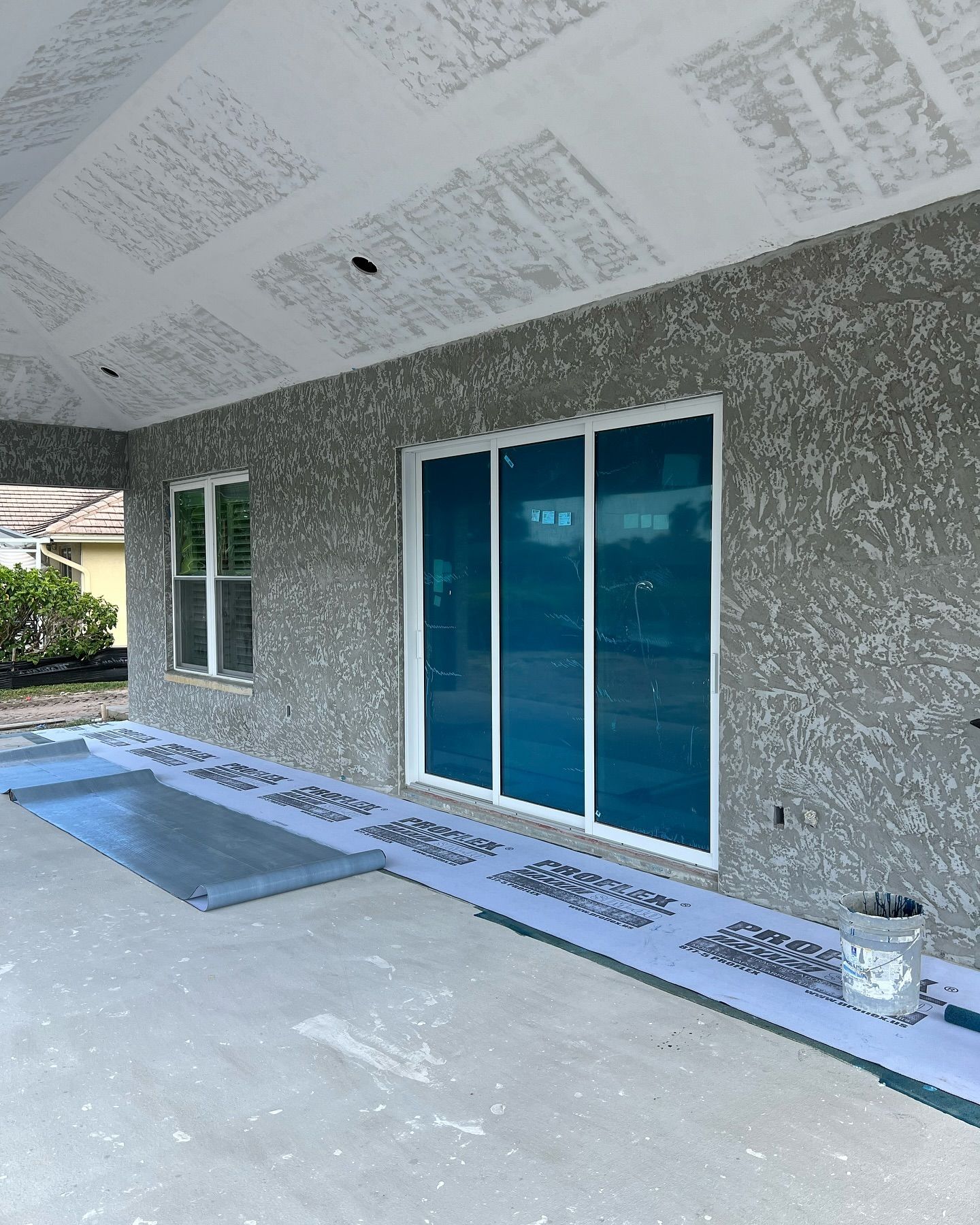 A house with a lot of windows is being painted.