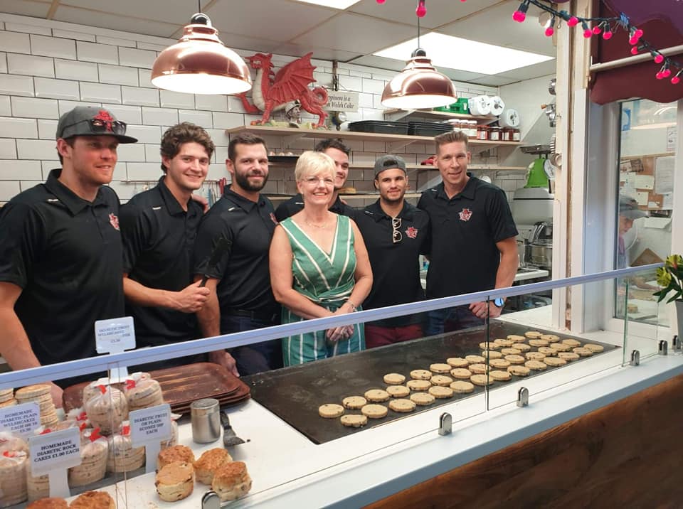 Bakestone Wales | A group of people are posing for a picture in a bakery.