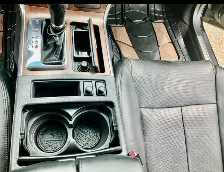 A close up of a car dashboard with a cup holder