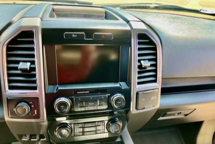 The interior of a toyota truck with the door open