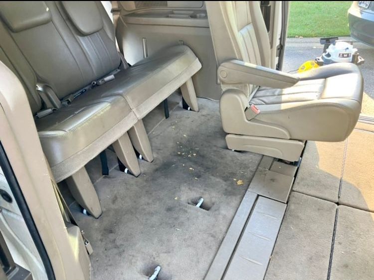 The dirty rear seats of a minivan are empty before cleaning