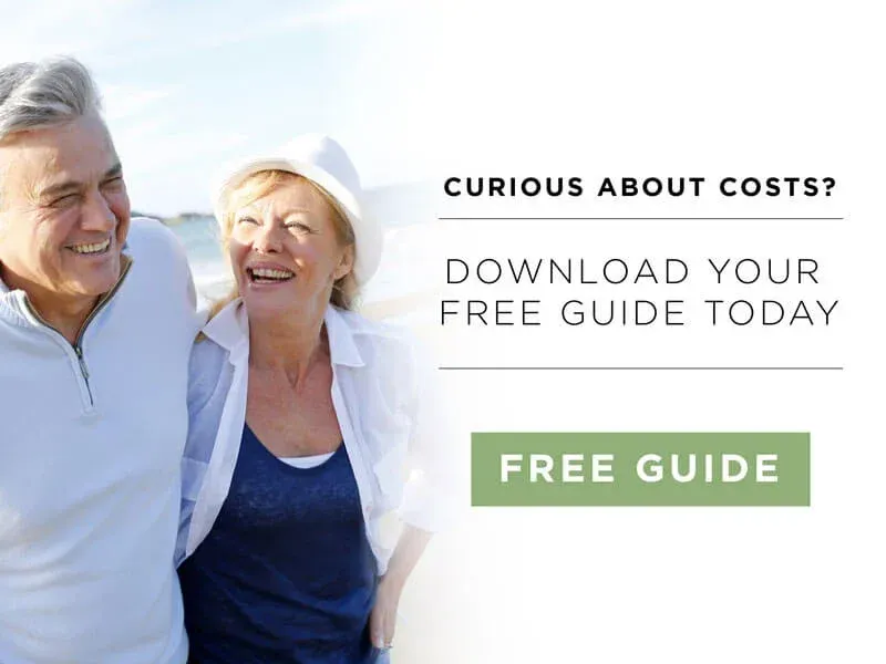 A man and a woman are standing next to each other on the beach.
