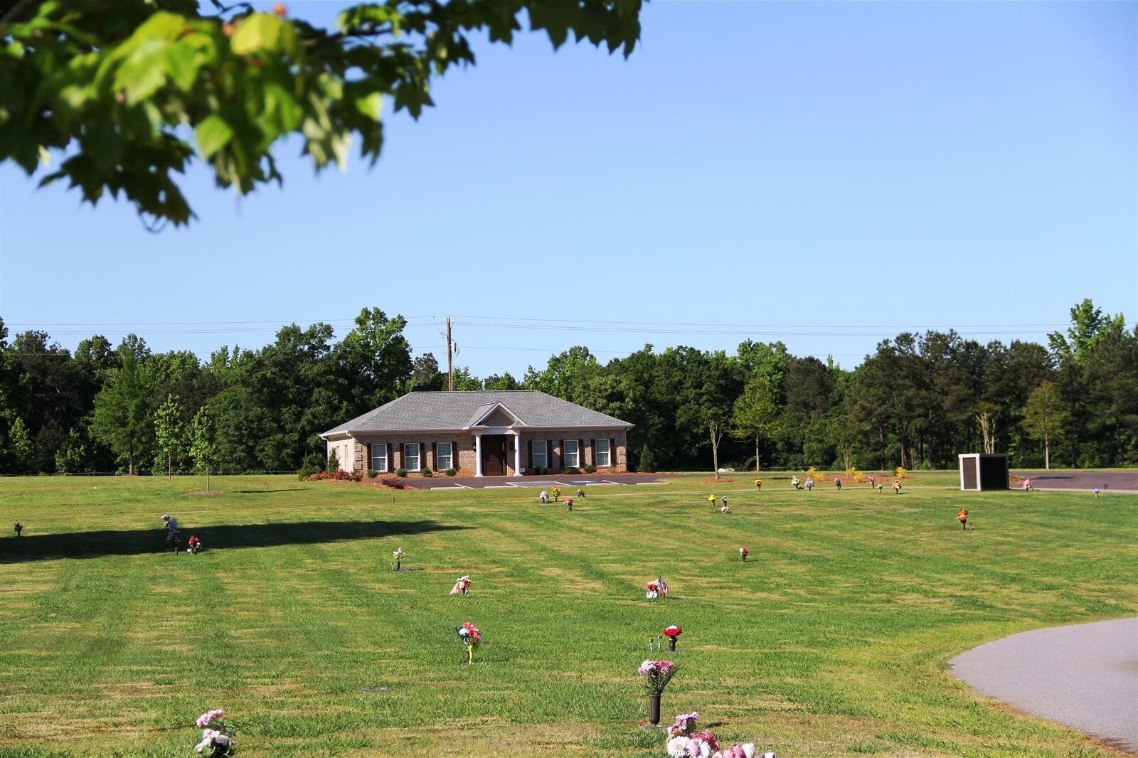 A cemetery with a house in the background