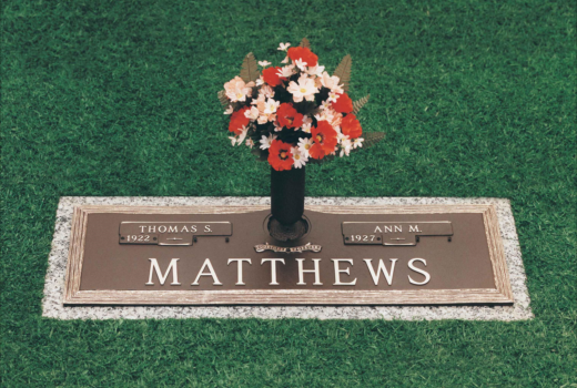 A grave for matthews with flowers in a vase