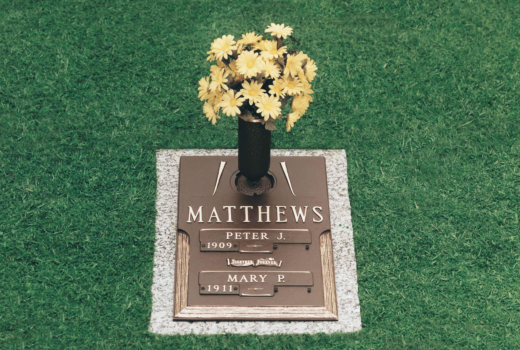 A grave for matthews with a vase of flowers