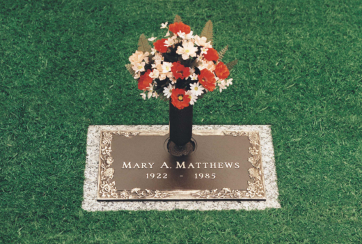 A grave of mary a matthews with a vase of flowers
