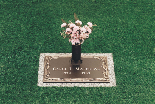 A grave for carol l matthews with flowers in a vase