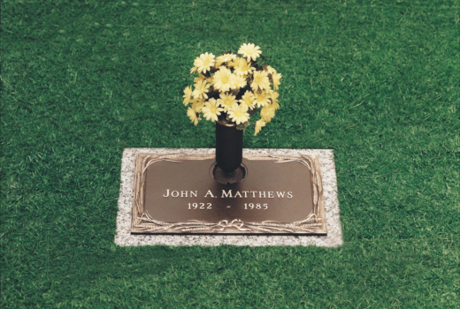 A grave for john a matthews with a vase of flowers