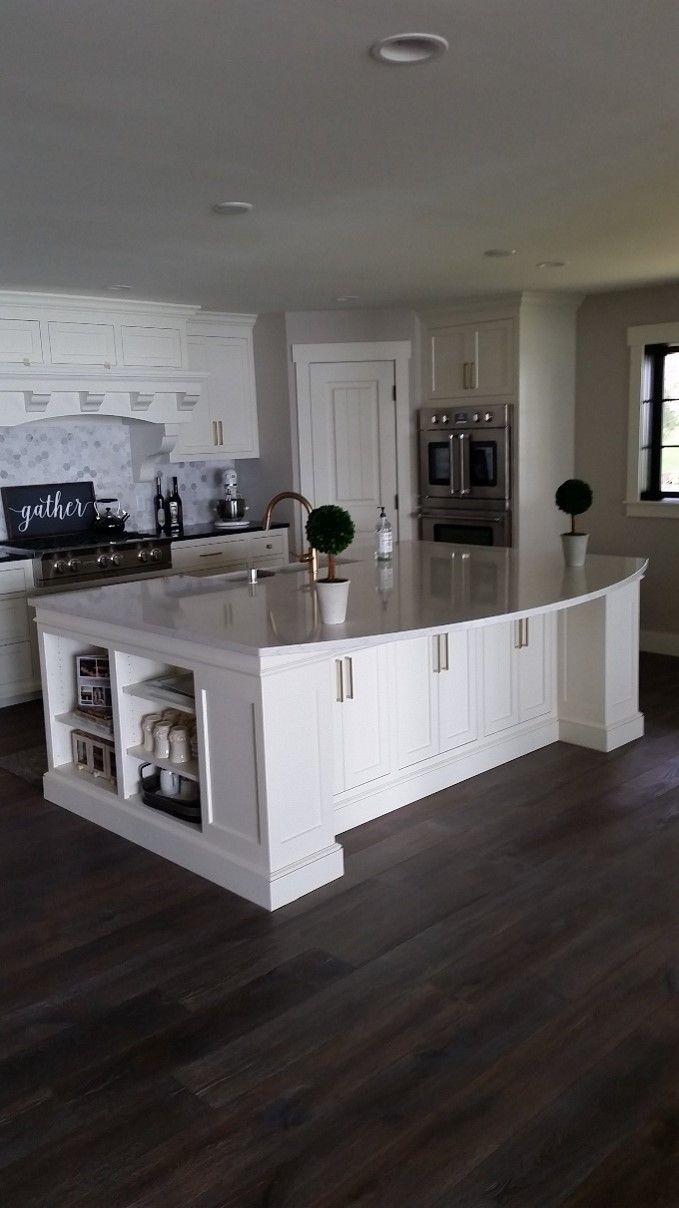 A kitchen with a large island in the middle of it.