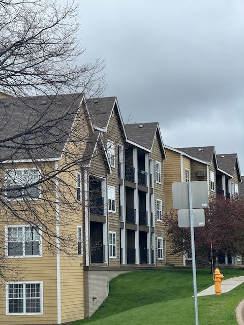 A row of apartment buildings with a fire hydrant in front of them