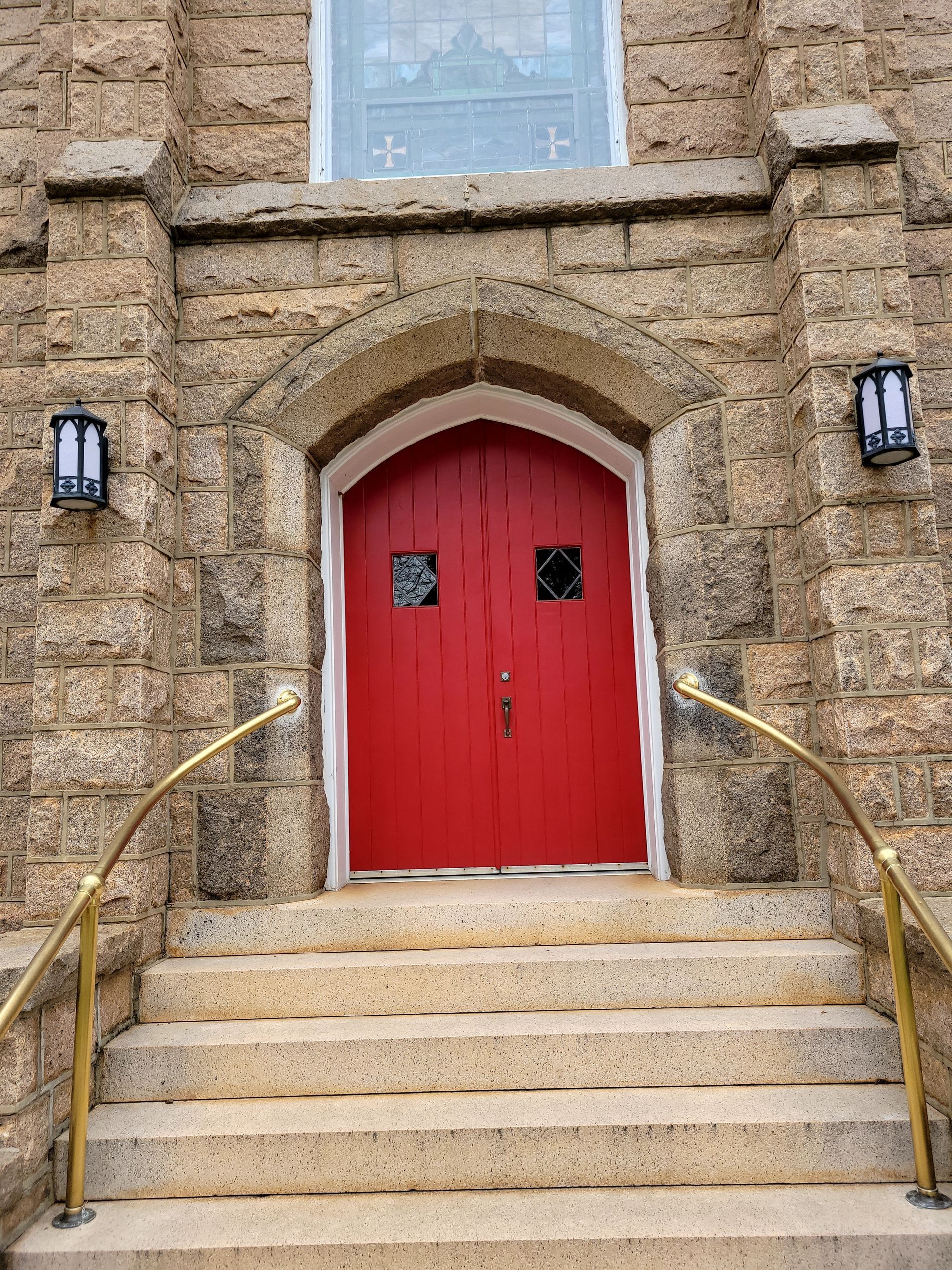 Hands exchanging a $100 bill. One hand is light-skinned, the other is darker. Background: blue and white.