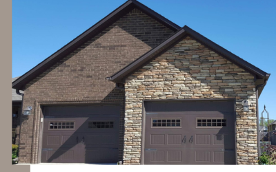A house exterior featuring a two-car garage with dark brown doors, split between dark brick and light stone siding.