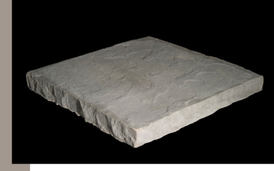 A single square, light grey concrete paver with a textured top and rough, stone-like edges against a black background.