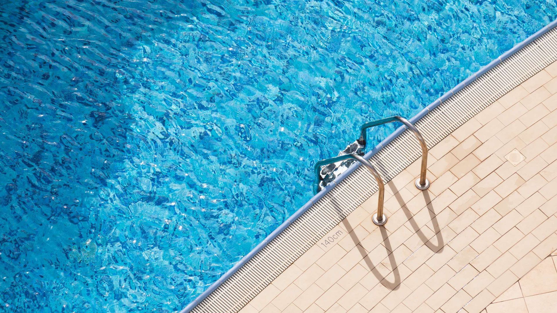 A swimming pool with stairs leading to the water.