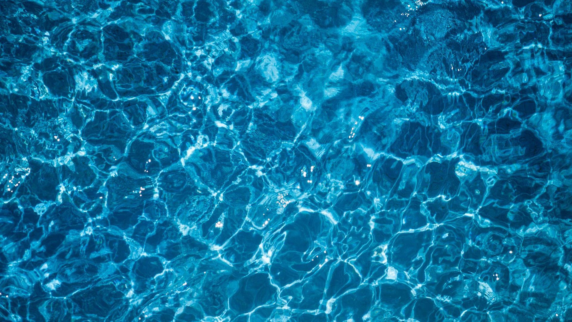 A close up of a blue water surface in a swimming pool.